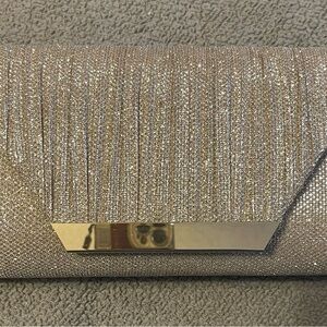 Champagne dazzling embellished clutch with shoulder chain included.